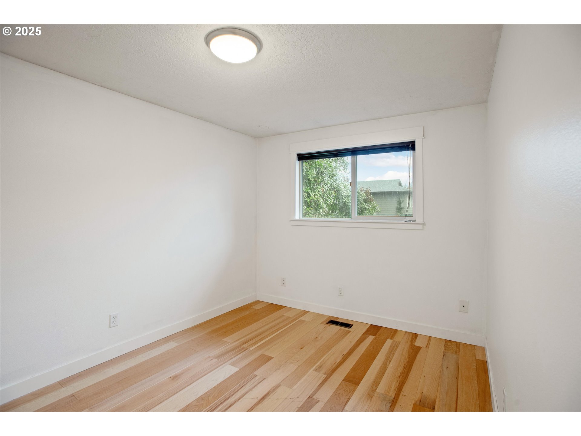 18800 Southwest Sandra Lane Beaverton, OR 97003 - Photo 28 of 41 an empty room with wooden floor and windows