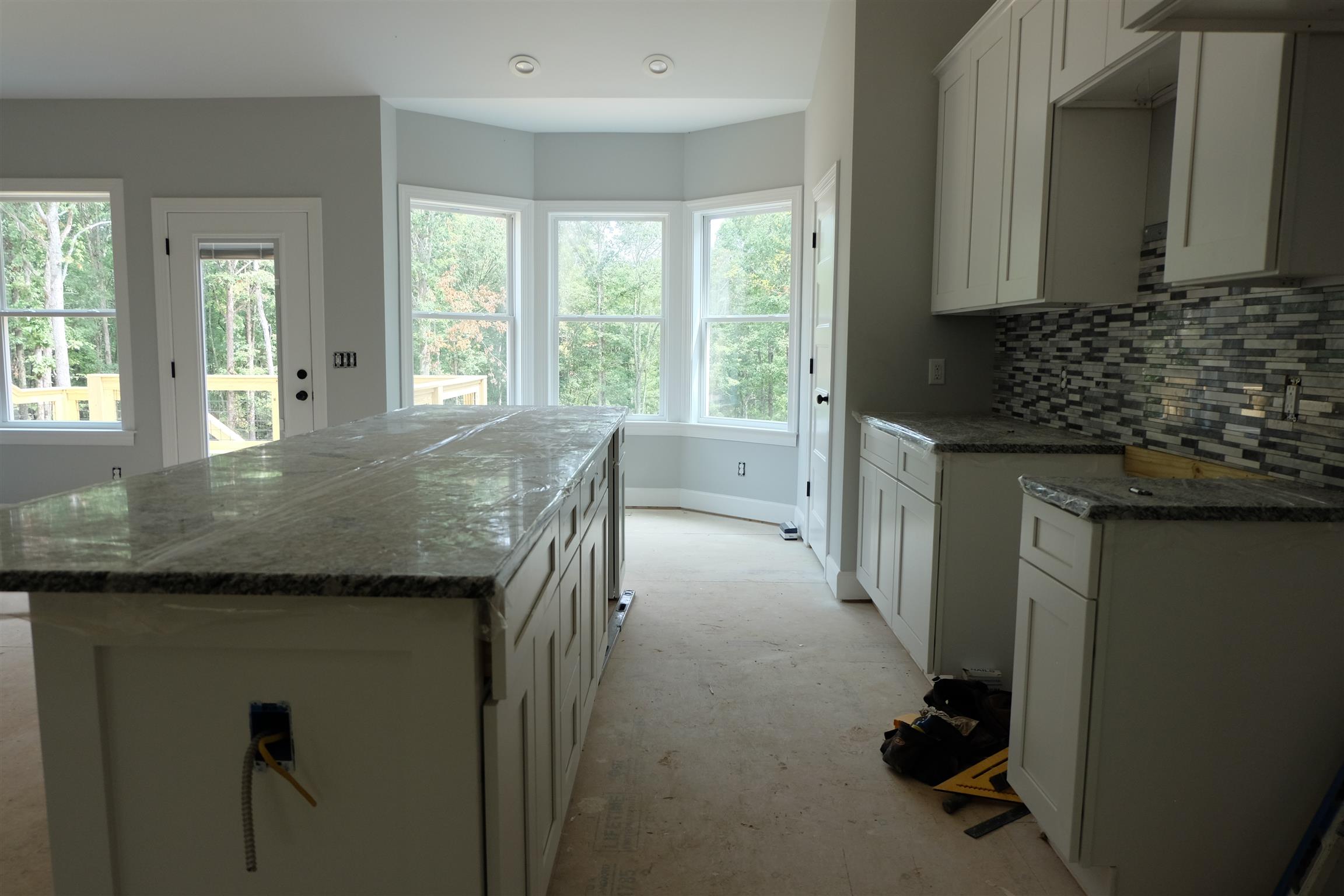 753 Billy Wynn Road Dickson, TN 37055 - Photo 11 of 22 a kitchen with granite countertop a stove and cabinets