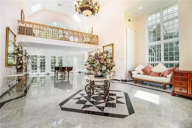 a living room with furniture chess table and a large window
