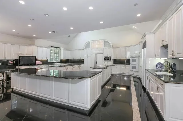 a large kitchen with stainless steel appliances lots of counter top space