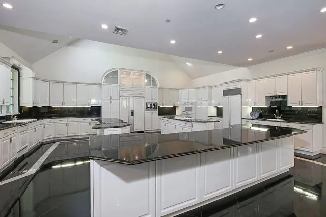 a large kitchen with granite countertop lots of counter top space
