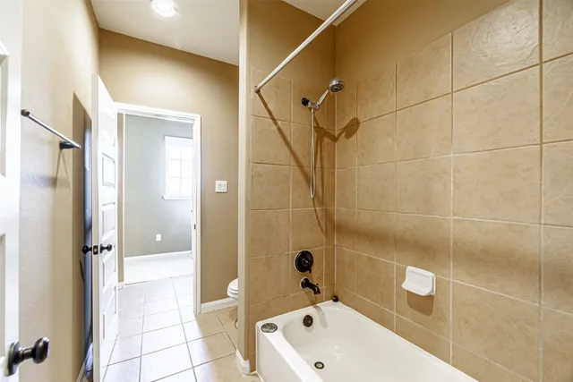 a en suite bathroom with a granite countertop sink mirror and a shower
