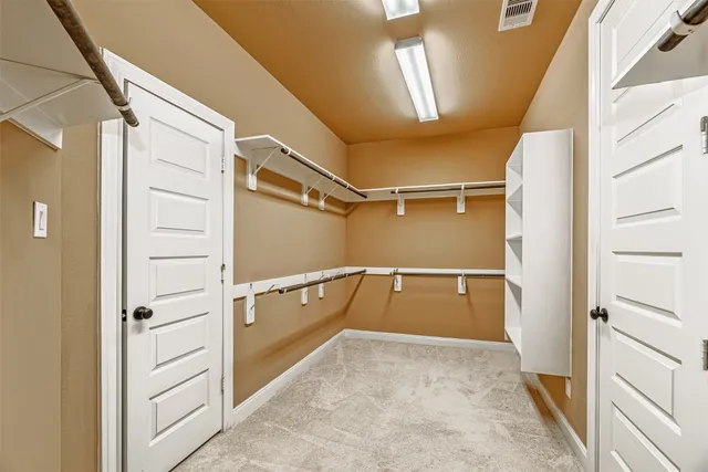 a bathroom with a tub a double vanity sink and mirror