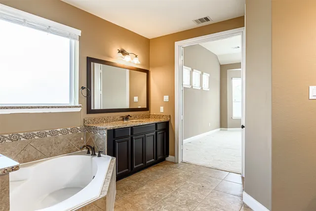 a bathroom with a tub and a shower