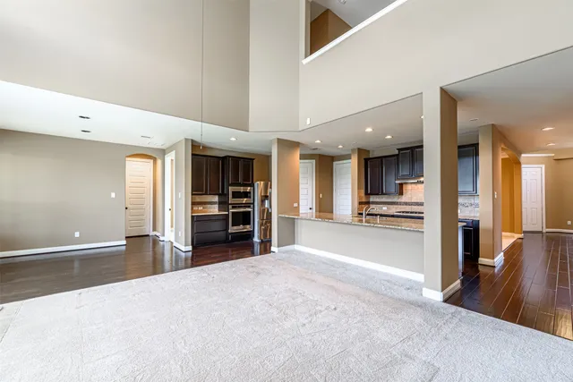 a view of an empty room with a fireplace and a window