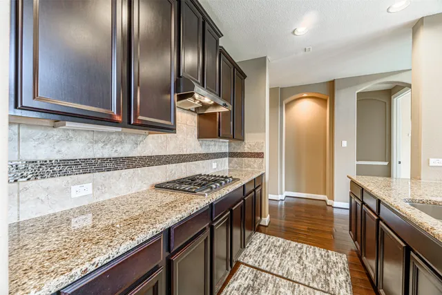 a bathroom with a granite countertop sink and a large mirror