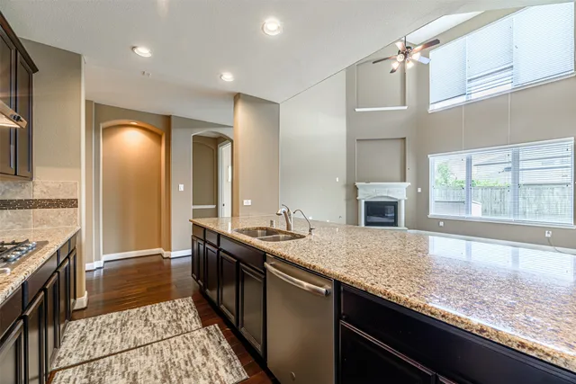 a kitchen with stainless steel appliances granite countertop a sink stove and refrigerator
