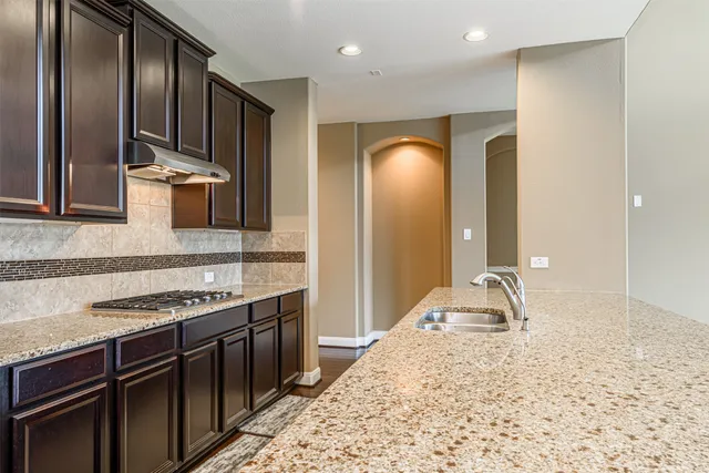 a living room with a stove and a refrigerator