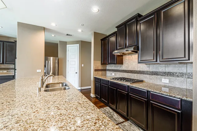 a bathroom with a shower sink vanity mirror and toilet
