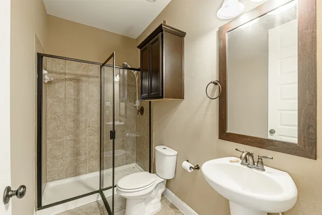 en empty room with wooden floor and chandelier