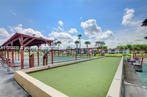 a view of a room with lots of wooden furniture and a chandelier
