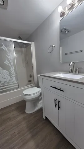 a white toilet sitting next to a bathroom sink