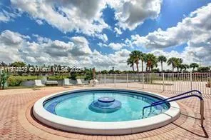 a view of a swimming pool with a lake in the background