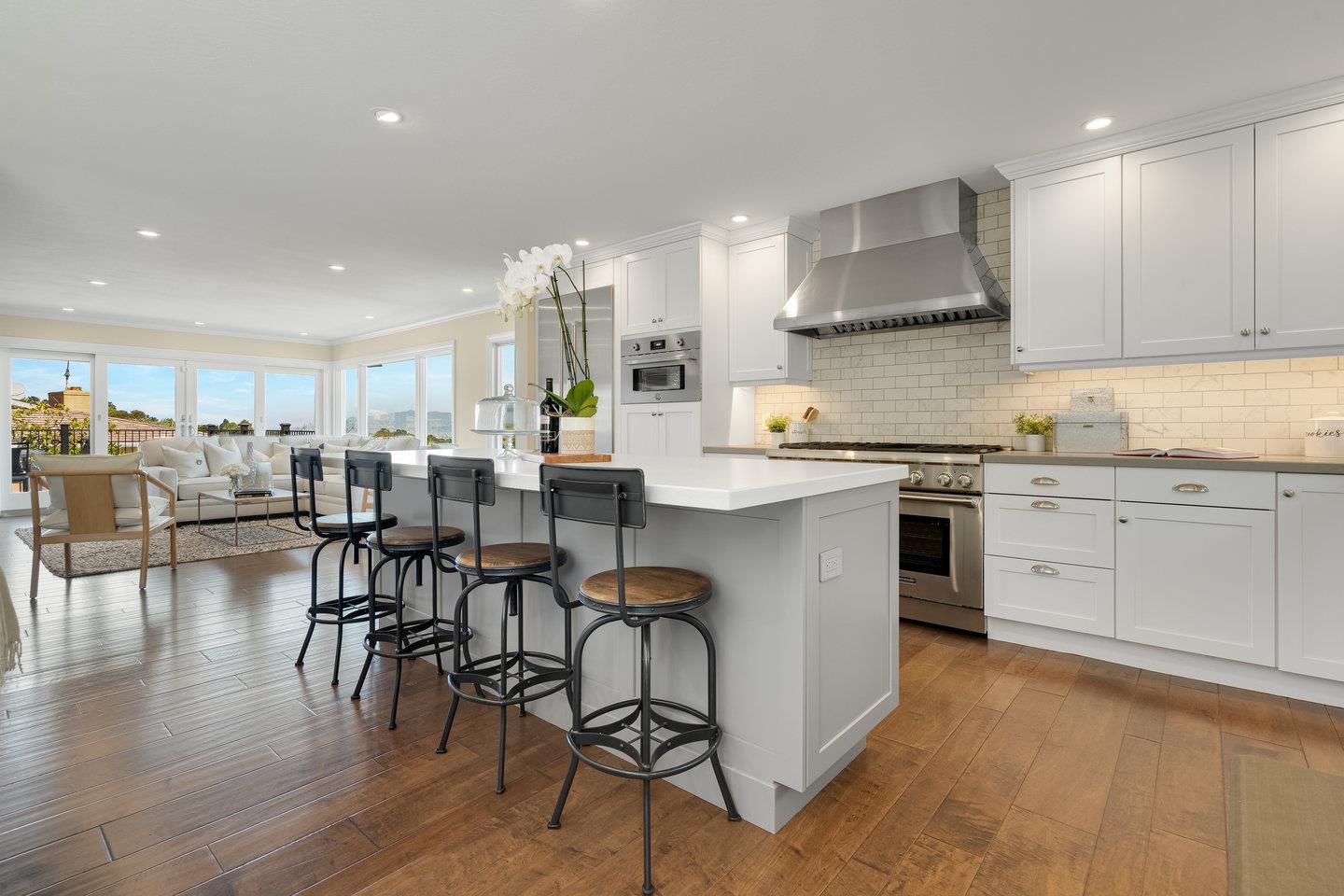 1270 Roble Road Millbrae, CA 94030 - Photo 12 of 35 a kitchen with stainless steel appliances a table chairs sink and cabinets