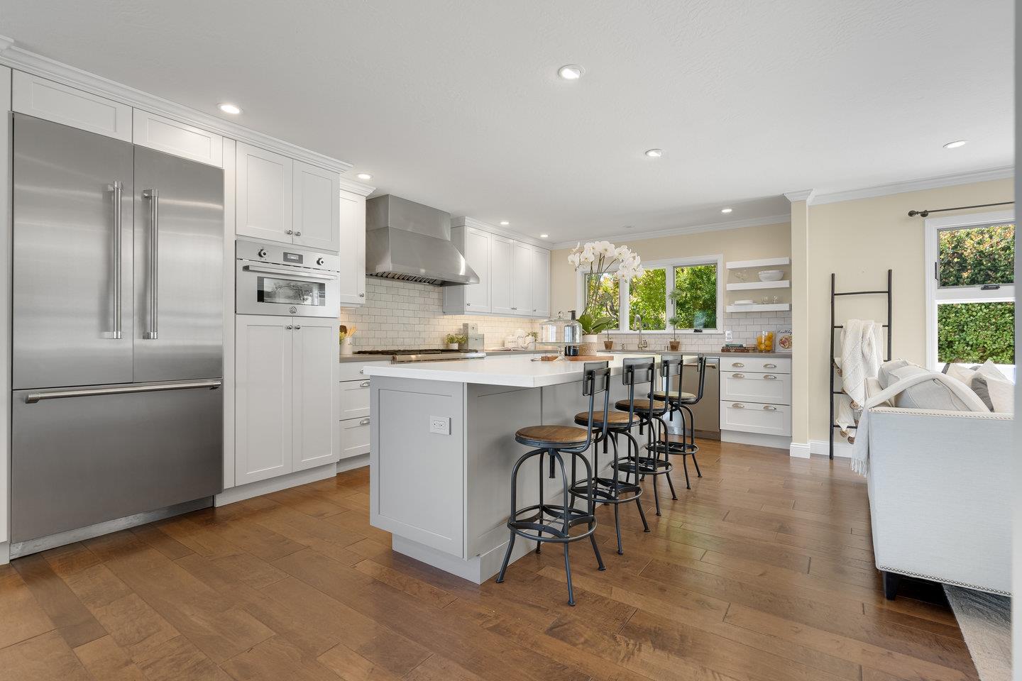 1270 Roble Road Millbrae, CA 94030 - Photo 13 of 35 a kitchen with stainless steel appliances kitchen island granite countertop a refrigerator a stove a sink a dining table and chairs