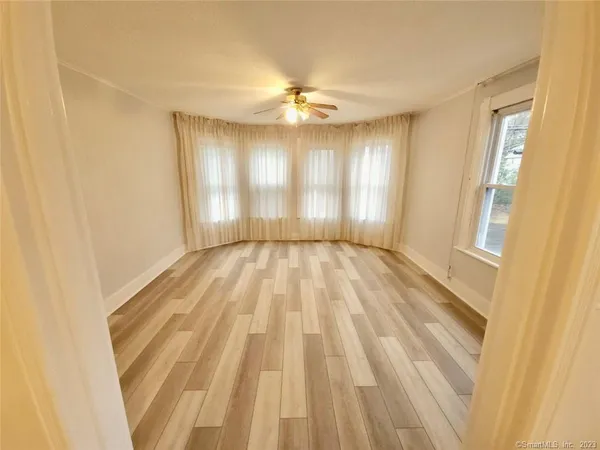 wooden floor in an empty room with a window