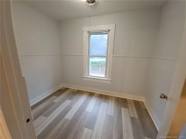 a view of room with window and hardwood floor