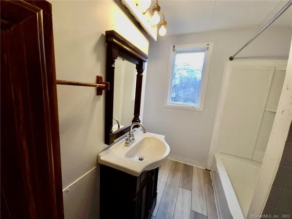 a bathroom with a sink a mirror and a toilet
