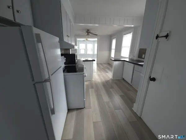 a kitchen with a refrigerator a sink and cabinets