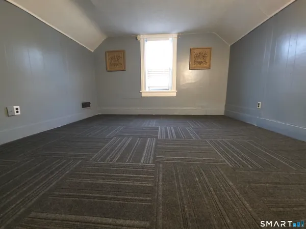 a view of a livingroom with wooden floor and window