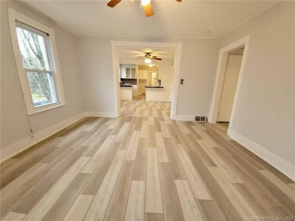 a view of a room with wooden floor and windows