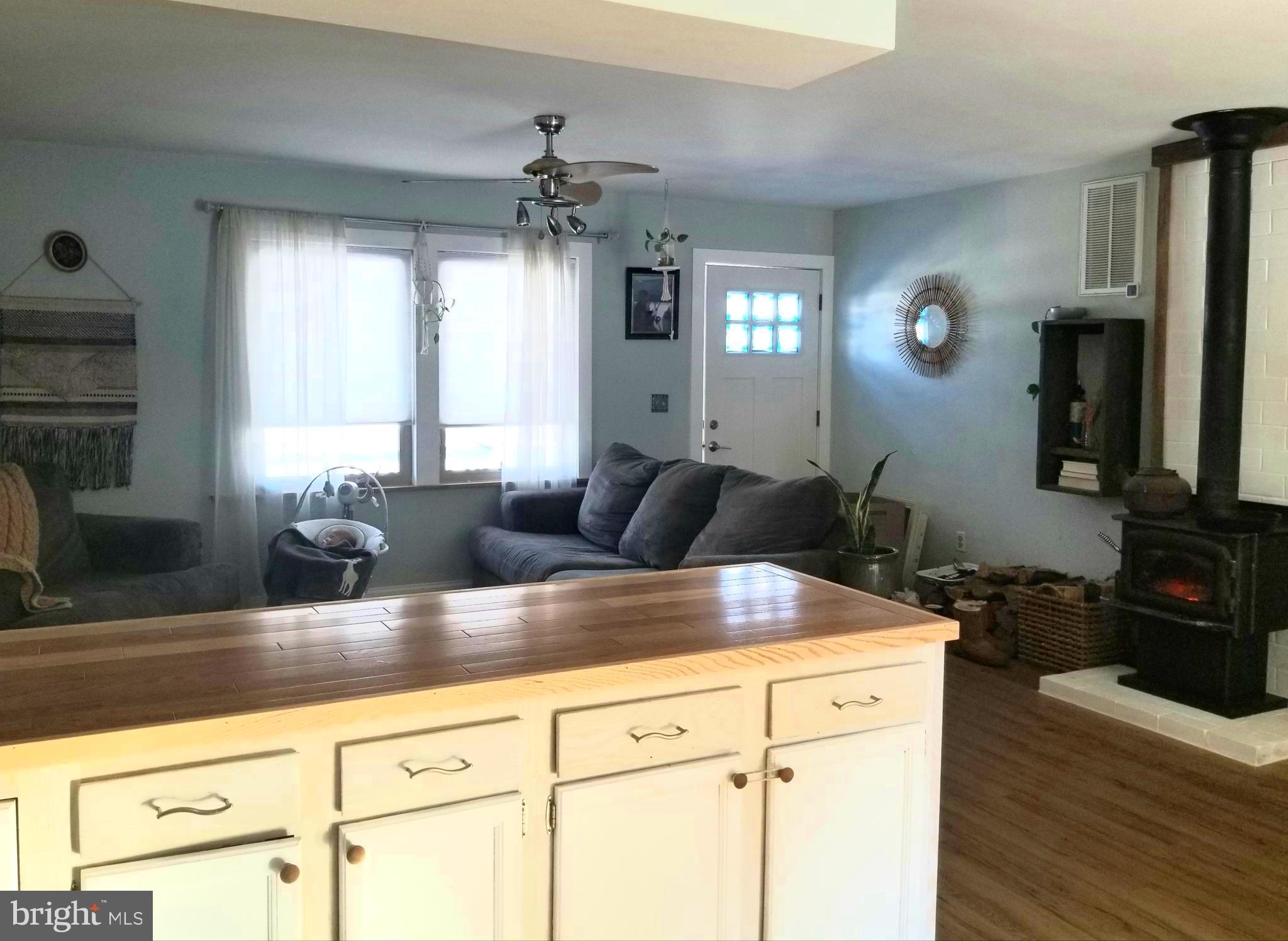 7741 Downs Road Newark, MD 21841 - Photo 6 of 22 a kitchen with kitchen island granite countertop a sink a counter space and cabinets