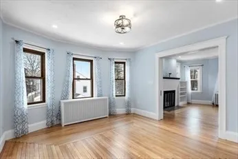 a view of livingroom with hardwood floor and a fireplace