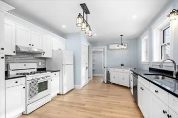 a kitchen with stainless steel appliances a stove sink and refrigerator