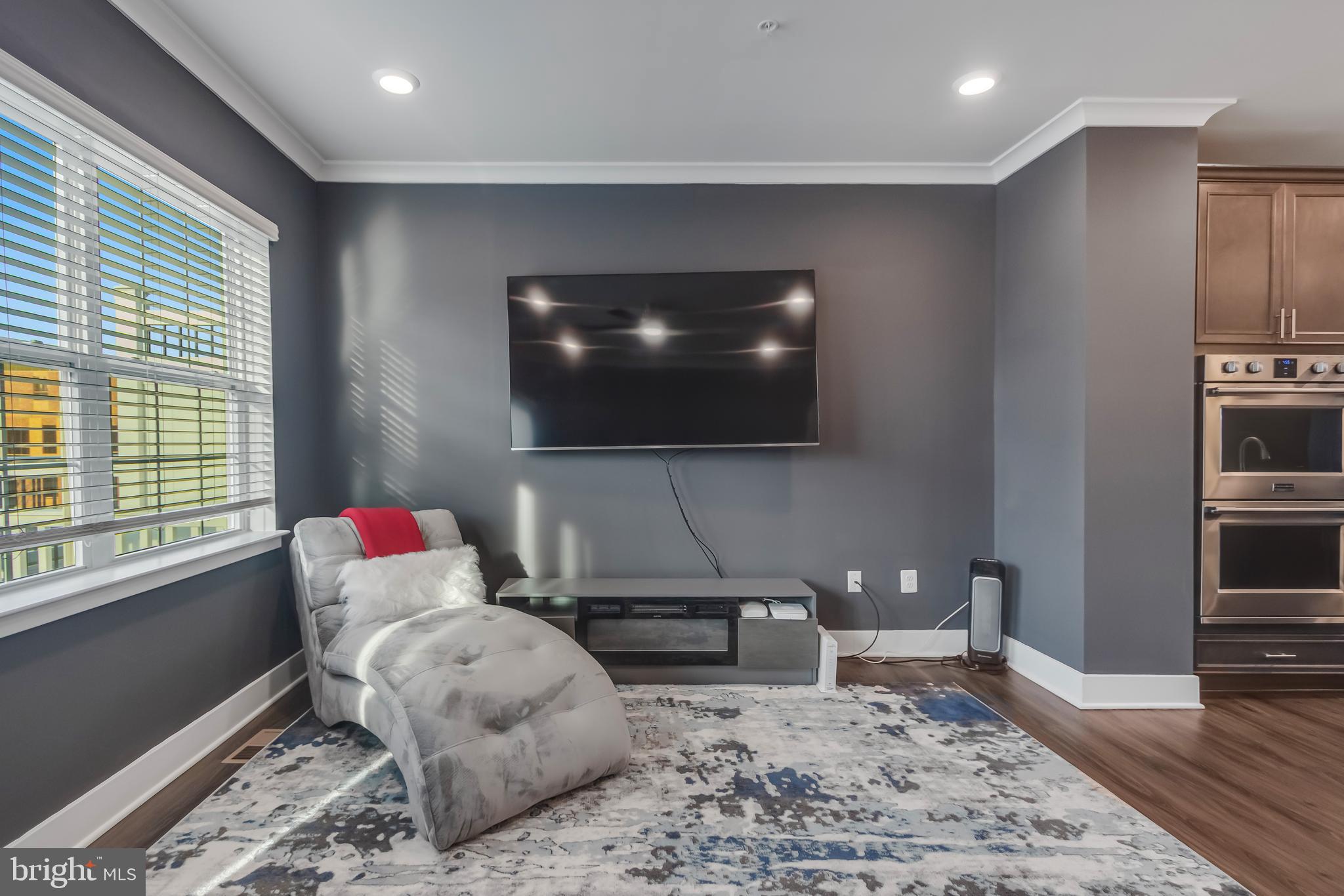 7806 Johnnycake Road Windsor Mill, MD 21244 - Photo 12 of 28 a living room with furniture and a flat screen tv