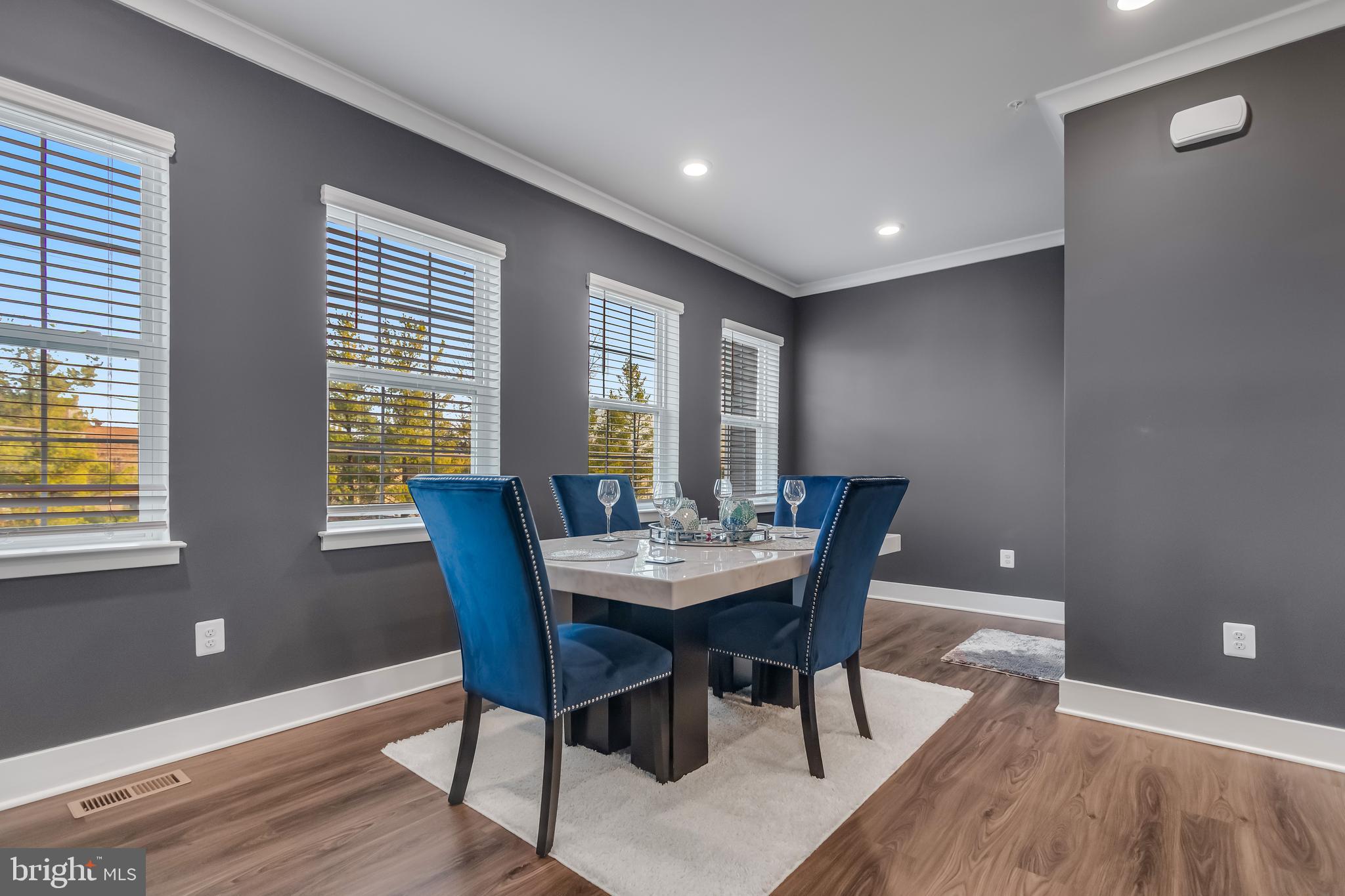 7806 Johnnycake Road Windsor Mill, MD 21244 - Photo 16 of 28 a view of a dining room with furniture window and wooden floor