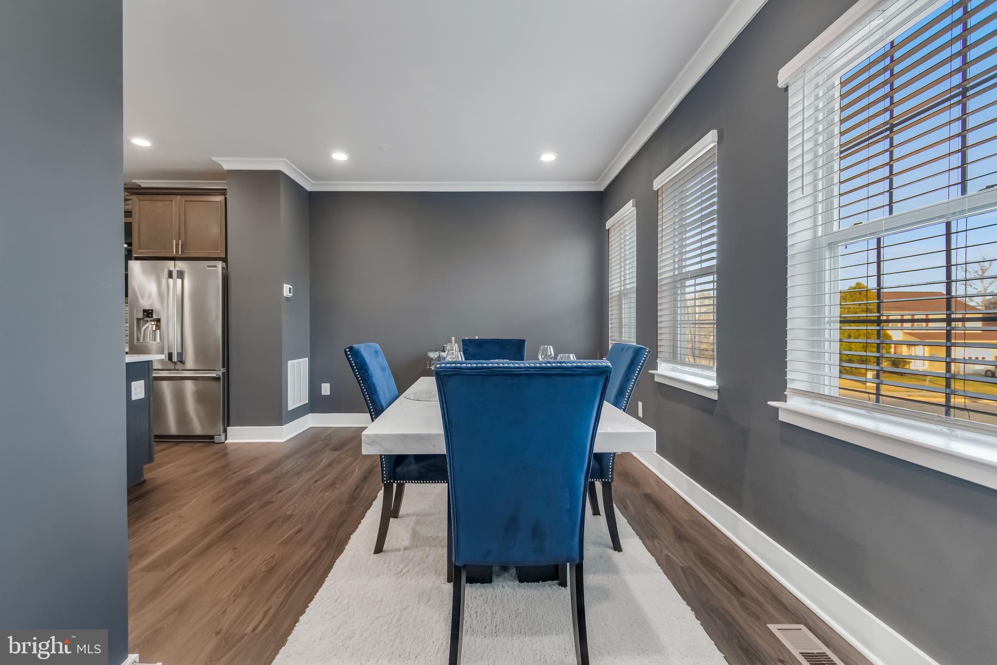 7806 Johnnycake Road Windsor Mill, MD 21244 - Photo 17 of 28 a view of a dining room with furniture window and wooden floor