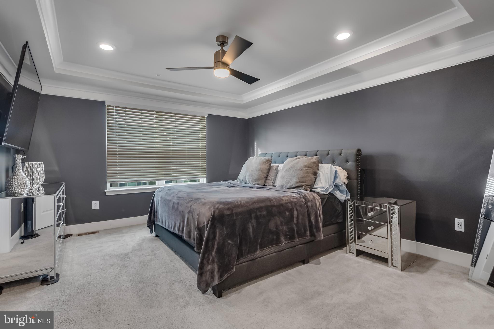 7806 Johnnycake Road Windsor Mill, MD 21244 - Photo 20 of 28 a spacious bedroom with a bed and a large mirror