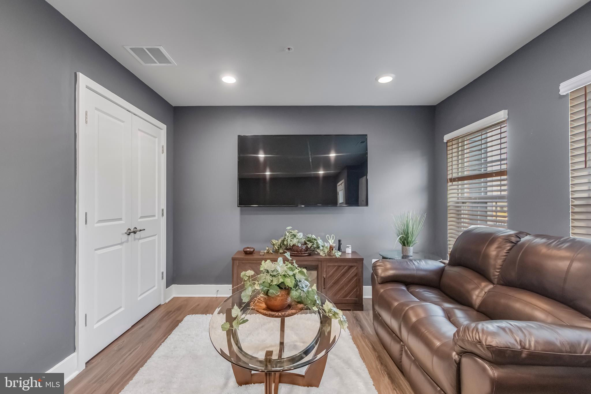7806 Johnnycake Road Windsor Mill, MD 21244 - Photo 5 of 28 a living room with furniture and a flat screen tv