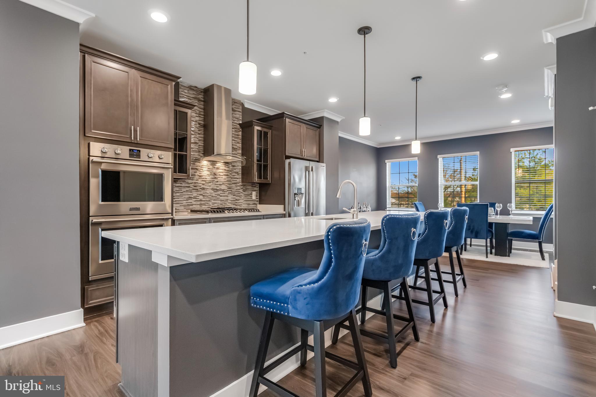 7806 Johnnycake Road Windsor Mill, MD 21244 - Photo 7 of 28 a large kitchen with a table and chairs