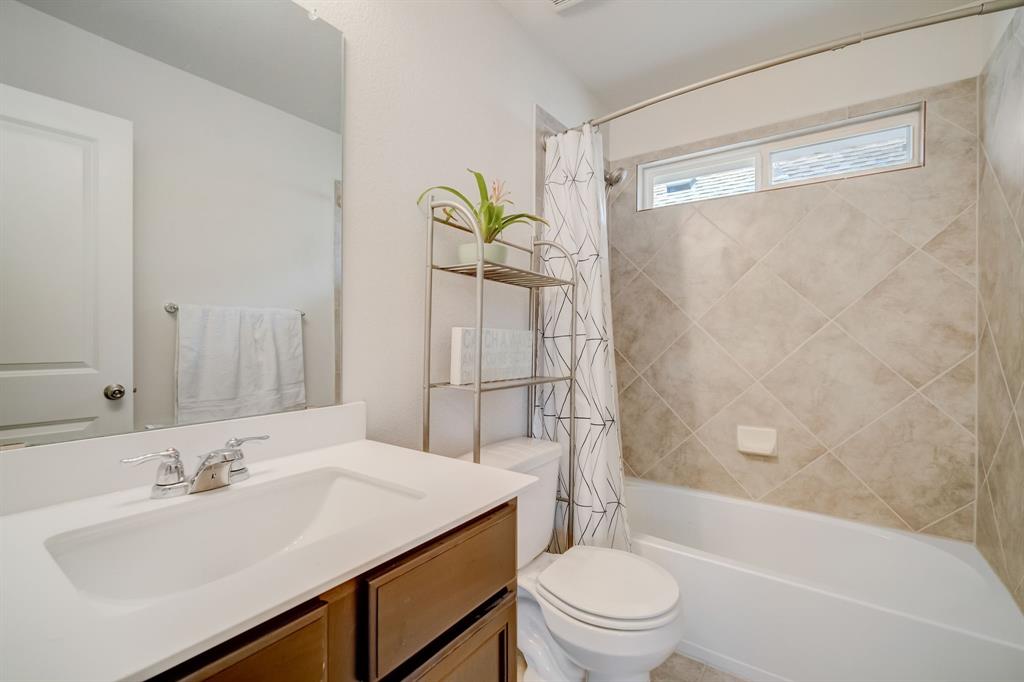 18002 Malnati Drive Pflugerville, TX 78660 - Photo 10 of 15 a bathroom with a sink toilet and shower