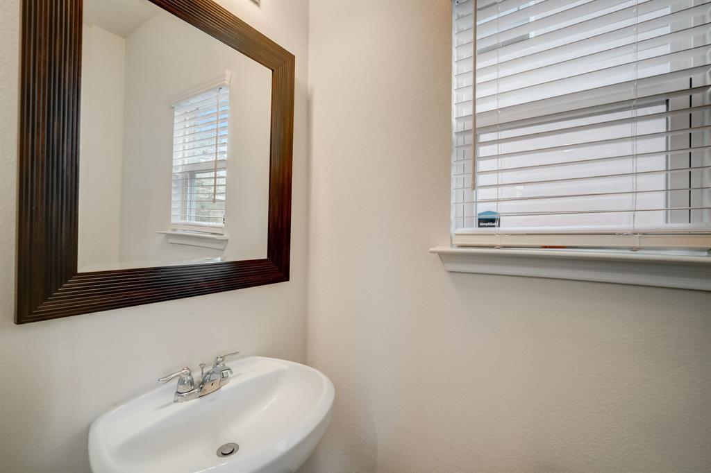 18002 Malnati Drive Pflugerville, TX 78660 - Photo 14 of 15 a bathroom with a sink and a mirror