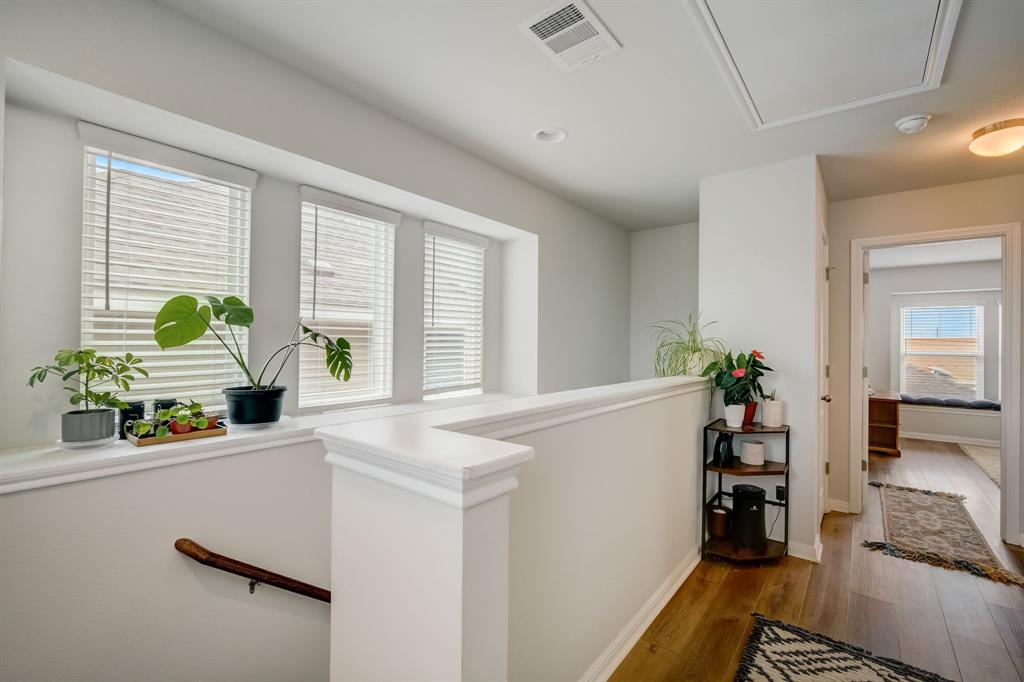18002 Malnati Drive Pflugerville, TX 78660 - Photo 8 of 15 a kitchen with a refrigerator a sink a counter space and windows
