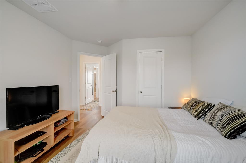 18002 Malnati Drive Pflugerville, TX 78660 - Photo 9 of 15 a bedroom with a bed and a flat screen tv