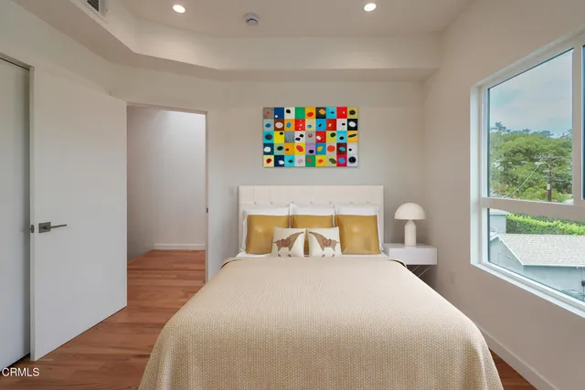 a bedroom with a bed and a large window