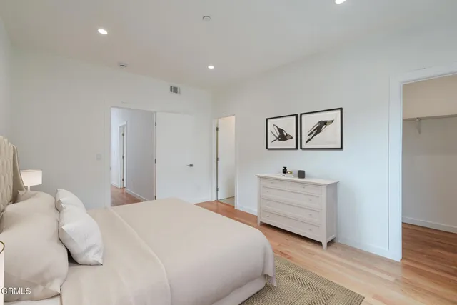 a bedroom with a bed and a dresser