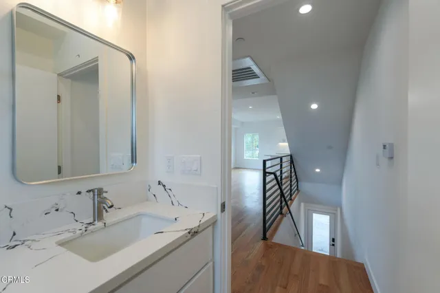 a bathroom with a sink and mirror