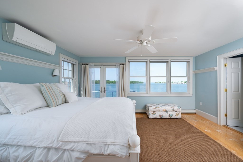 87 Bay Street Hull, MA 02045 - Photo 12 of 25 a large bed sitting in a bedroom next to a window with a dresser