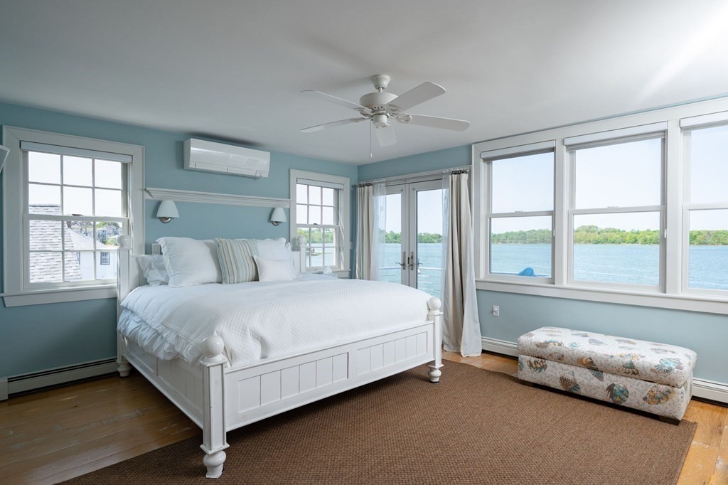 87 Bay Street Hull, MA 02045 - Photo 13 of 25 a bed sitting in a bedroom next to a window