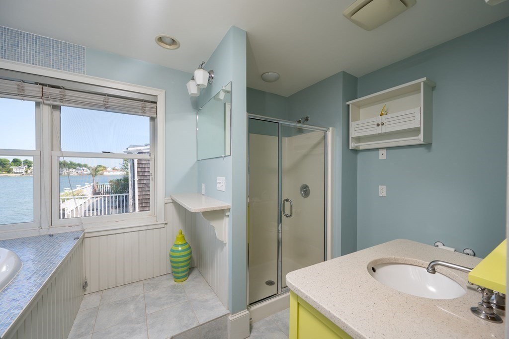 87 Bay Street Hull, MA 02045 - Photo 16 of 25 a bathroom with a granite countertop sink and a mirror
