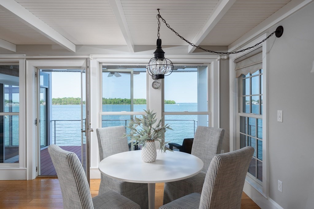 87 Bay Street Hull, MA 02045 - Photo 6 of 25 a dining room with furniture a chandelier and wooden floor