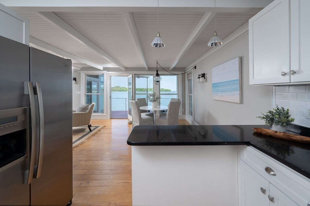 87 Bay Street Hull, MA 02045 - Photo 7 of 25 a kitchen with stainless steel appliances granite countertop a refrigerator a sink a stove and cabinets