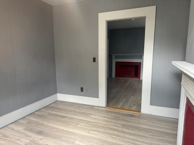 a view of a hallway with wooden floor and a hallway
