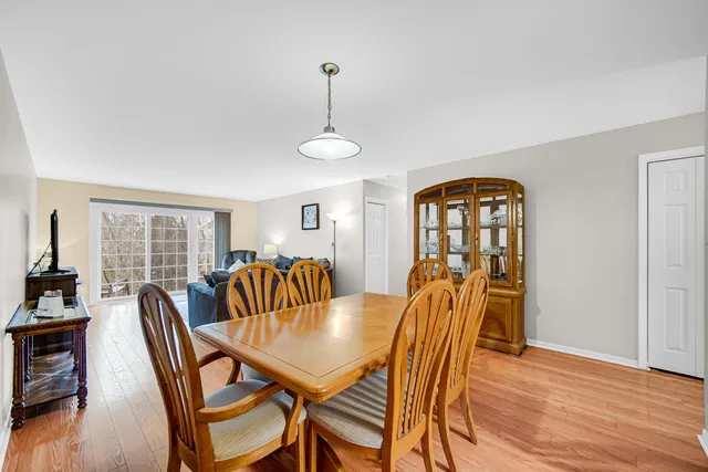a dining room with furniture a chandelier and wooden floor