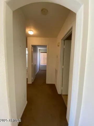 a view of a hallway with wooden floor
