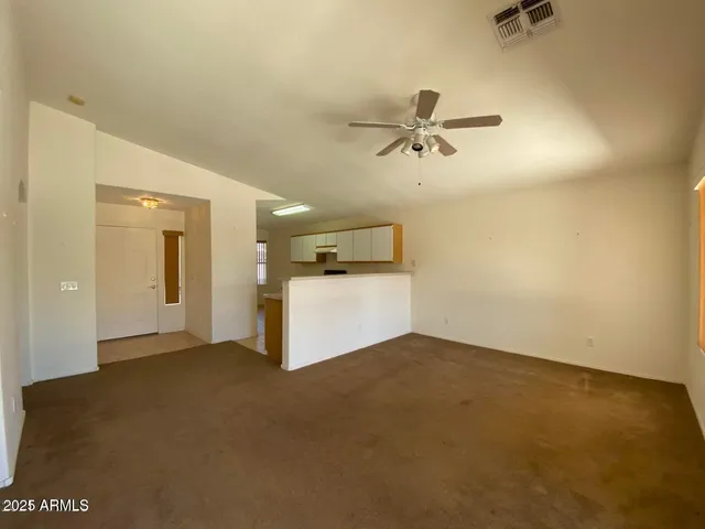 a view of a livingroom with a ceiling fan hardwood and a ceiling fan